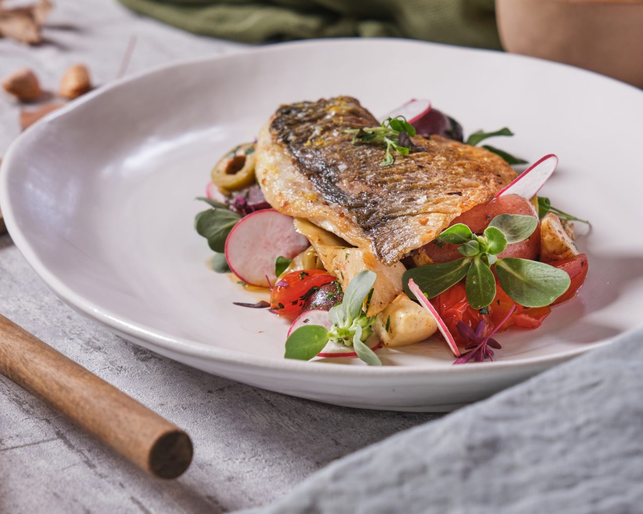 Fragrant Bream Fillet with Artichokes, Cherry Tomatoes and Green Olives served with Baby Potatoes